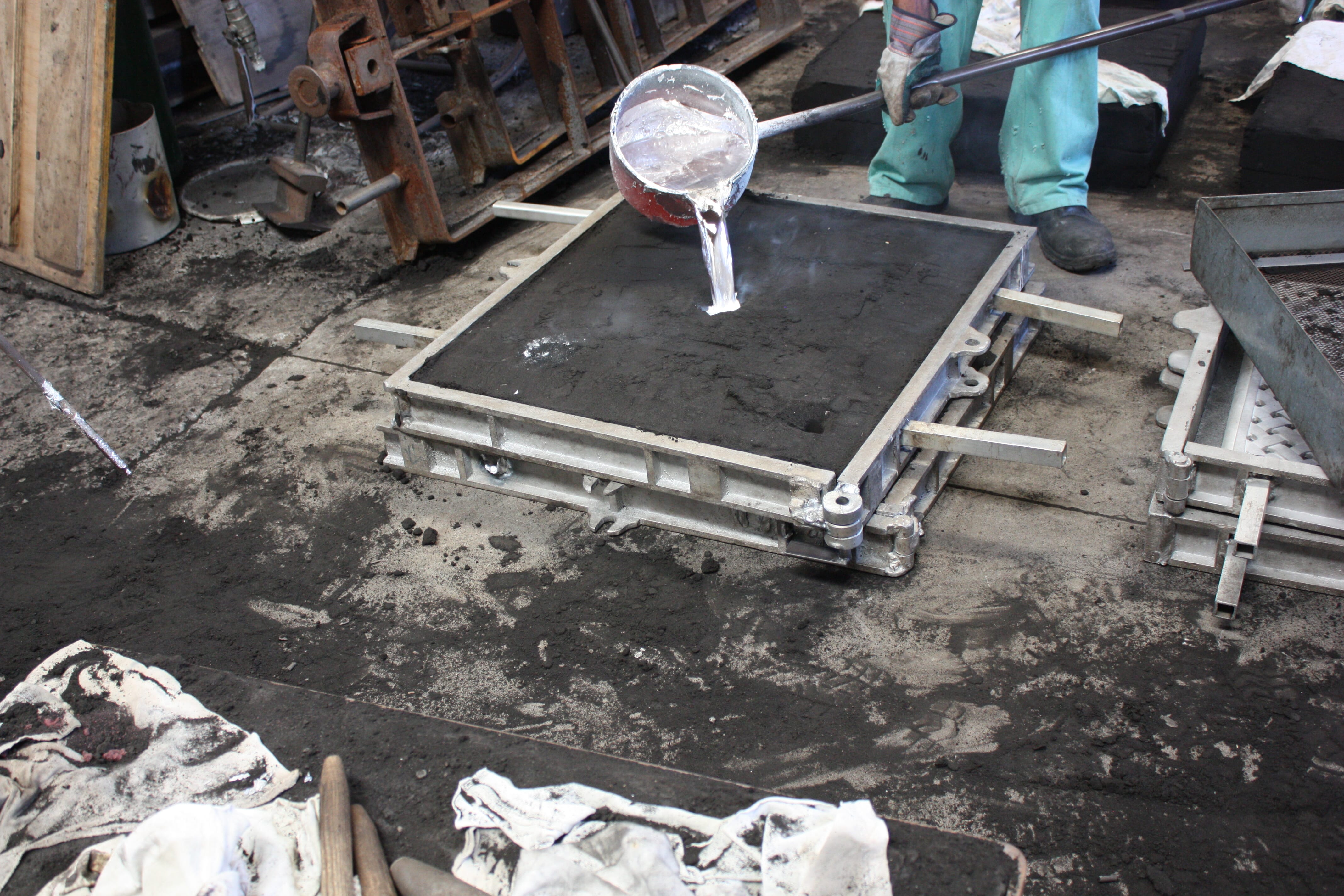 Pouring liquid aluminium into sand cast